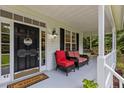 Inviting front porch featuring comfortable seating and a welcoming entrance with a decorative wreath at 92 Summer Dawn, Pittsboro, NC 27312