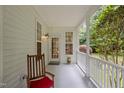 Cozy side porch with a rocking chair, perfect for relaxing and enjoying the outdoor scenery at 92 Summer Dawn, Pittsboro, NC 27312