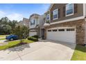 Three townhomes feature stone accents, neutral siding, white garage doors, and well-maintained landscaping at 9302 Nellman Ln, Raleigh, NC 27617