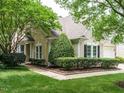 Beautifully landscaped yard with lush green grass, manicured shrubs, and a well-maintained two-story home at 101 Lake Tillery Dr, Cary, NC 27519