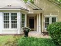 Inviting front entrance with large windows, flower pot, and a well-lit porch, perfect for a warm welcome at 101 Lake Tillery Dr, Cary, NC 27519