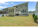 Spacious backyard with lush lawn, privacy fence, and a patio perfect for outdoor entertaining at 1013 Poppy Fields Ln, Wake Forest, NC 27587