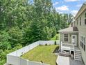 A well-manicured backyard with a white fence offers a serene and private outdoor space at 1013 Poppy Fields Ln, Wake Forest, NC 27587