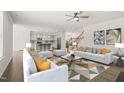 Bright, open-concept living room with modern furnishings and hardwood floors at 1013 Poppy Fields Ln, Wake Forest, NC 27587