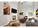 Staged living room with fireplace, vaulted ceiling, hardwood floors, and access to the backyard at 1016 Goldmist Ln, Durham, NC 27713