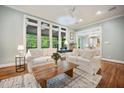 Bright living room with hardwood floors, large windows, and neutral decor, perfect for relaxing or entertaining at 105 Gorge Ct, Cary, NC 27518