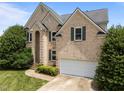Charming two-story brick home featuring a well-manicured lawn, attached garage, and decorative shutters at 105 Mcnaughton Ct, Garner, NC 27529