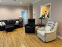Cozy living room with hardwood floors and comfortable seating arrangements at 105 Perry Ln, Zebulon, NC 27597