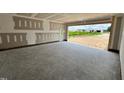 A large two-car garage with exterior door, ready for finishing touches and providing direct access to the outdoors at 107 Lynn Ln, Selma, NC 27576
