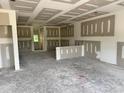 Spacious garage with drywall installed, offering ample space for parking and storage, plus a convenient interior door at 107 Lynn Ln, Selma, NC 27576