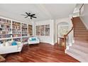 Spacious living room featuring hardwood floors, custom built-in bookshelves, and elegant seating at 108 Teagan Ct, Chapel Hill, NC 27516
