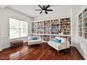Bright living room featuring custom built-in bookshelves, hardwood floors, and elegant decor at 108 Teagan Ct, Chapel Hill, NC 27516