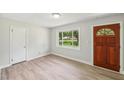 Bright living room with a front door and modern flooring at 10900 Poole Rd, Wendell, NC 27591