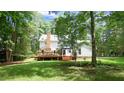 Expansive backyard with a deck, lush lawn, and mature trees, perfect for outdoor living at 12037 Deer Run, Raleigh, NC 27614