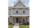 Inviting townhouse exterior with a covered porch, perfect for relaxing and enjoying the neighborhood views at 121 Longleaf Pine St, Clayton, NC 27527