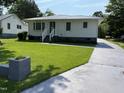Charming home with a well-manicured lawn and inviting front entrance at 129 S Bullock St, Henderson, NC 27536