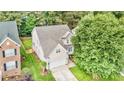Aerial view of a two-story home showcasing its landscaped yard and neighborhood at 1304 Trailing Rose Ct, Wake Forest, NC 27587