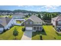 Aerial view of a home with a large yard in a residential neighborhood with mature trees and a playground nearby at 1305 Ivey Grove Ct, Fuquay Varina, NC 27526