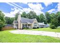 Lovely home featuring a well-manicured lawn, mature trees, and a charming exterior at 1309 Sweet Charm Ln, Knightdale, NC 27545