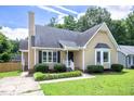 Charming home featuring black shutters, a well-maintained lawn, and inviting front yard landscaping at 1309 Sweet Charm Ln, Knightdale, NC 27545
