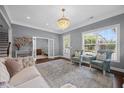 Elegant living room with hardwood floors, decorative chandelier, and large windows at 1330 Rodessa, Raleigh, NC 27607