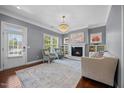 Bright living room featuring a fireplace, hardwood floors, and a decorative chandelier at 1330 Rodessa, Raleigh, NC 27607