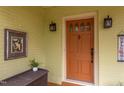 Close-up of the front door with stylish sconces, offering a warm welcome at 1405 Pennsylvania Ave, Durham, NC 27705