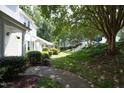Well-manicured landscaping and inviting walkway enhance this peaceful community setting at 146 Greenmont Ln, Cary, NC 27511