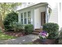 Charming townhome entrance with brick steps and vibrant flower accents at 146 Greenmont Ln, Cary, NC 27511