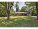 Charming single-story home with mature trees and a well-maintained lawn at 1613 Euclid Rd, Durham, NC 27713
