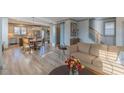Bright, open living space with hardwood floors, connecting the living room to the kitchen and staircase at 1624 Tunnel St, Wendell, NC 27591