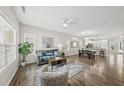 Open living room and dining area with hardwood floors and natural light pouring in from bright windows at 1625 Main Divide Dr, Wake Forest, NC 27587