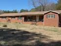 Charming brick home with a covered front porch and spacious front yard at 1802 Holiday Rd, Sanford, NC 27330