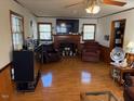 Cozy living room with hardwood floors and a brick fireplace at 1802 Holiday Rd, Sanford, NC 27330