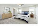 Neutral staged main bedroom with an upholstered headboard, ensuite, and an abundance of natural light at 200 Sweet Violet Dr, Youngsville, NC 27596