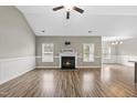 Bright living room boasts hardwood floors, fireplace, and wainscoting detail, perfect for entertaining at 241 Fox Run, Benson, NC 27504