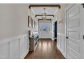 Bright foyer with hardwood floors, decorative lighting, and paneled walls at 243 E Wellesley Dr, Clayton, NC 27520
