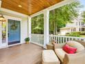 Welcoming front porch with seating, a wreath on the blue front door, and a charming view of the neighborhood at 244 Elmcrest Dr, Holly Springs, NC 27540