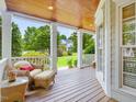 Inviting front porch with comfortable seating, showcasing a serene outdoor living space at 244 Elmcrest Dr, Holly Springs, NC 27540