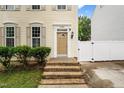 Inviting front entrance with brick steps, detailed door, and manicured landscaping creating a warm welcome at 2445 Sapphire Valley Dr, Raleigh, NC 27604