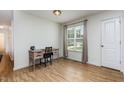 Bright bedroom with hardwood floors and a desk with a chair next to a large window at 281 Kinsman Ct, Fuquay Varina, NC 27526