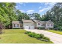 Beautiful home with a well-maintained lawn, two-car garage, inviting entryway, and stylish red shutters at 281 Kinsman Ct, Fuquay Varina, NC 27526