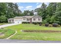 Inviting exterior featuring a manicured lawn, two-car garage, tasteful landscaping, and classic red shutters at 281 Kinsman Ct, Fuquay Varina, NC 27526