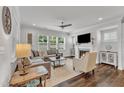 Bright living room with a fireplace, ceiling fan, and large sectional sofa at 2969 Thirlestane Dr, Apex, NC 27502