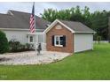 Home exterior featuring a detached structure, flagpole, and well-maintained lawn at 3409 Bennyfield Ct, Fuquay Varina, NC 27526