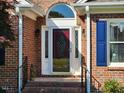 Elegant front door with decorative glass, sidelights, and brick surround at 3409 Bennyfield Ct, Fuquay Varina, NC 27526
