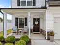 Cozy front porch featuring rocking chairs and a 'Welcome' door decor at 3613 Cross Timber Ln, Raleigh, NC 27603