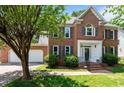 Charming brick home with a well-manicured lawn, front-facing garage, and detailed window shutters at 3720 Bridgeton Park Dr, Raleigh, NC 27612