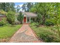 Cozy single-story home with a well-maintained front yard and quaint walkway at 414 W Markham Ave, Durham, NC 27701