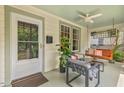Relaxing front porch featuring a porch swing, ceiling fan, and comfortable seating at 414 W Markham Ave, Durham, NC 27701